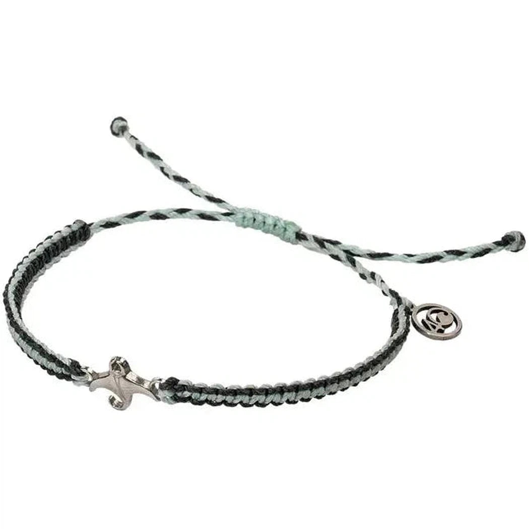 A close-up of the 4Ocean Respect the Locals Manta Ray Bracelet with a black and gray woven design, silver clasp, and charm, against a white background.