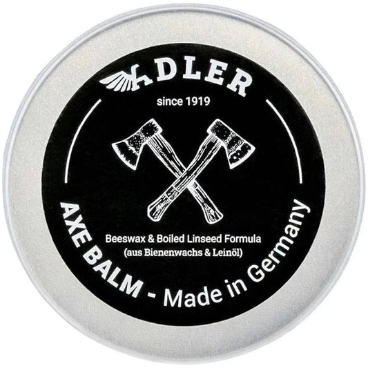 A round tin of Adler Axe Balm with crossed axes on the label, showing the product name and "Made in Germany" text.