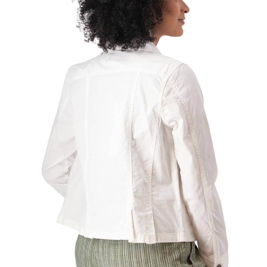 Back view of the Aventura Women's Arden V2 Jacket in White on a model wearing green striped pants against a white background.