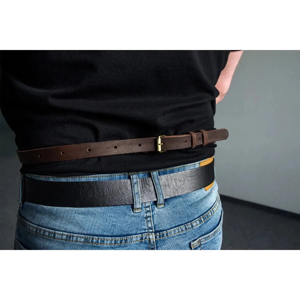 Back view of the Beavercraft Adjustable Brown Leather Work Apron on a model wearing blue jeans with a gray wall background.