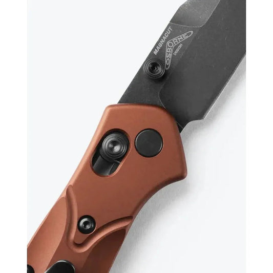A close-up of the Benchmade Osborne knife with a brown handle and black blade, showing the lock mechanism and branding against a white background.