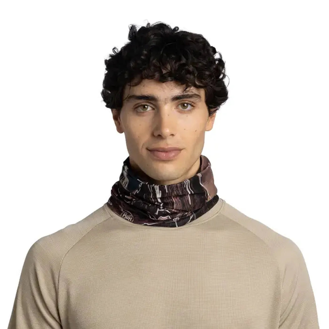 A front view of the Buff CoolNet UV Insect Shield - Teroy multi-colored bandana worn by a model against a white background.