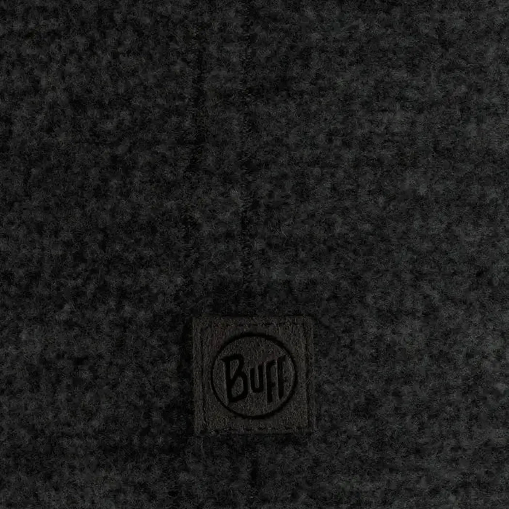 A close-up of the Buff Merino Fleece Headband Vente Prive in Black showing the brand tag on a dark fabric background.