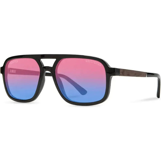 Side view of the Camp Eyewear Glacier: Grateful Dead Stealie Edition sunglasses with black frames and gradient pink to blue lenses against a white background.