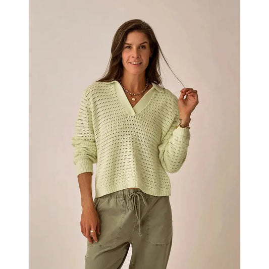 A woman wearing the Carve Designs Women's Morgan Polo Sweater in Cloud stands against a neutral background.