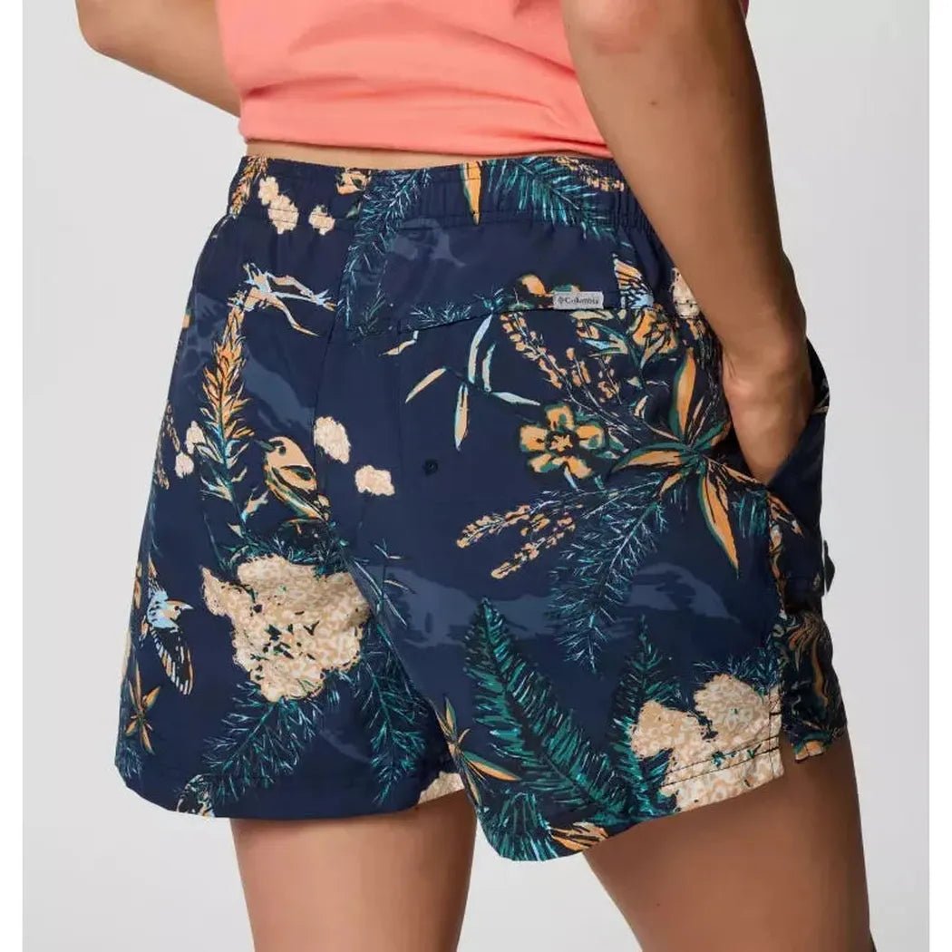 Back view of the Columbia Sportswear Women's Sandy River Printed Short III in Snowdrift Pasteled, showing the floral print and model wearing them against a plain background.