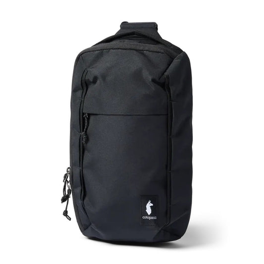 A front view of the black Cotopaxi Todo 8L Sling with a zippered pocket and logo patch against a white background.