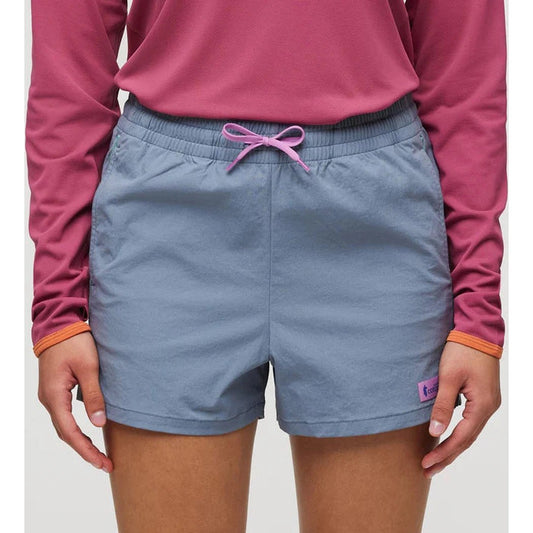 A front view of the Cotopaxi Women's Brinco Short in Tempest color with a pink drawstring and a small purple tag on the right leg.