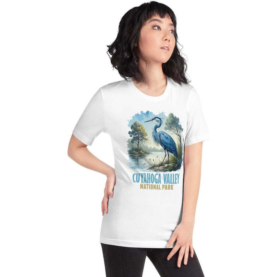 A woman in a white Cuyahoga Valley Clothing Company CVNP Blue Heron T - Shirt poses with one hand on her hip against a plain background.
