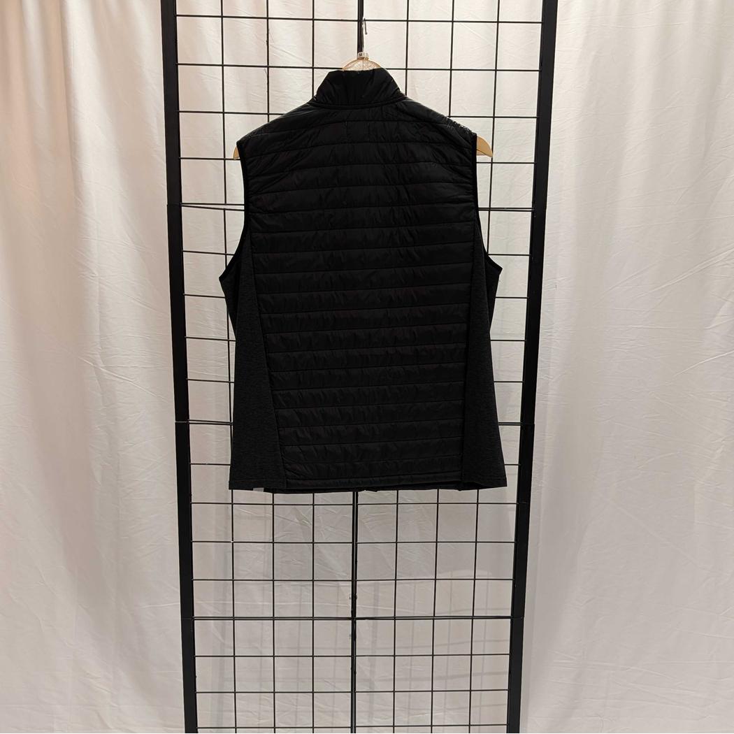 Back view of the Cuyahoga Valley Clothing Company Men's Synthetic Vest in Naval Academy color hanging on a wire grid against a white curtain.