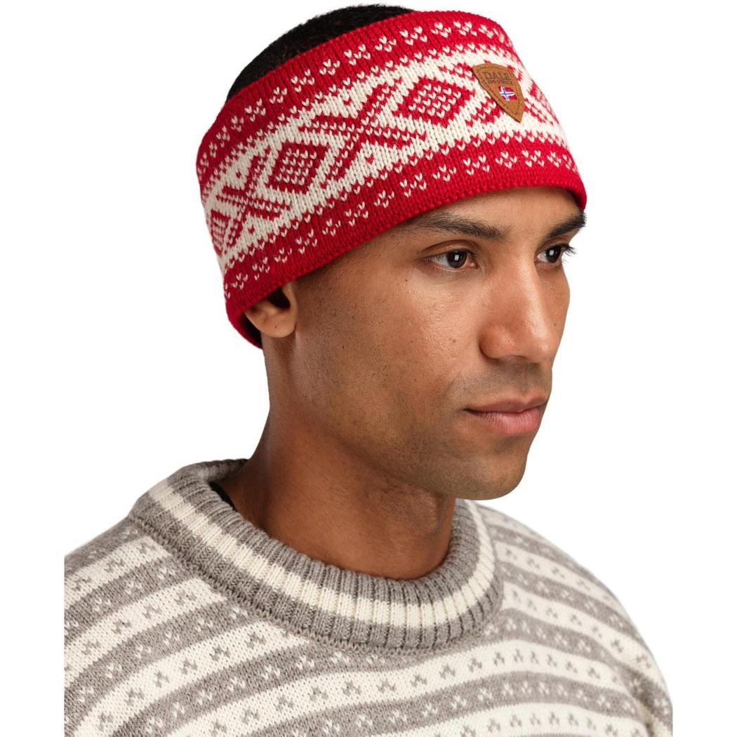 A side view of the Dale Of Norway Cortina 1956 Headband in Navy White on a model wearing a striped sweater against a white background.