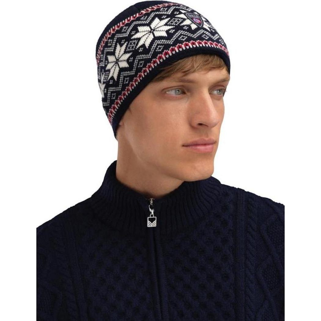 Side view of the Dale Of Norway Garmisch Hat in Navy Offwhite Red on a model wearing a navy zip sweater against a white background.