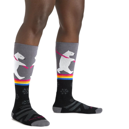 A person wearing black Darn Tough Women's Thermolite Due North Over-the-Calf Midweight Ski & Snowboard Socks with gray tops and colorful accents, photographed from the side against a white background.