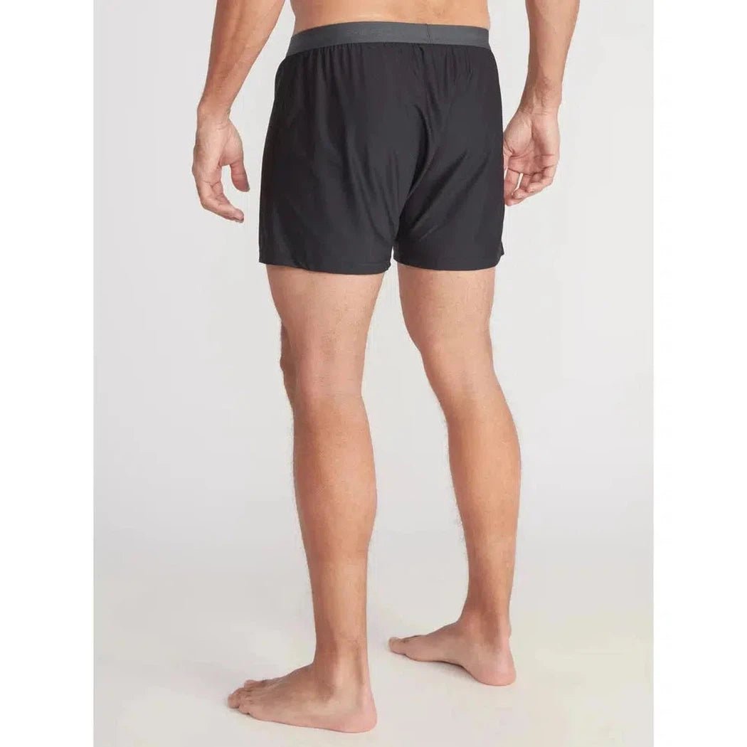 Back view of the Exofficio Men's Give-N-Go 2.0 Boxer in Asparagus/Cobblestone on a barefoot model against a plain white background.