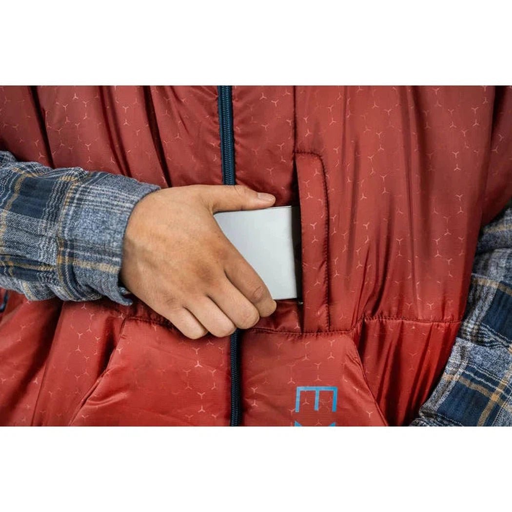 A hand reaches into the pocket of the Burgundy Exped Dreamwalker sleeping bag, showing the interior pocket feature.