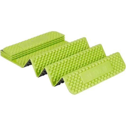 Four green Exped Flex 1.5R sleeping pads are stacked and spread out, showing their textured surface and a white background.