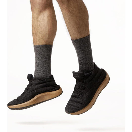 Side view of the FITS Light Hiker Crew in Coal showing the thick charcoal socks and black hiker shoes against a white background.