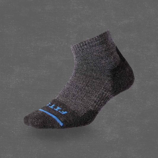 Side view of the FITS Light Hiker Quarter in Coal showing the blue stripe and heel on a gray background.
