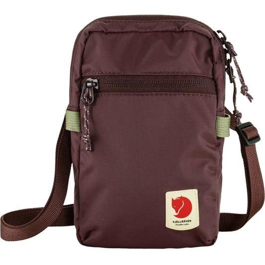 A front view of the Fjallraven High Coast Pocket in Black showing the front zipper pocket and adjustable shoulder strap against a white background.