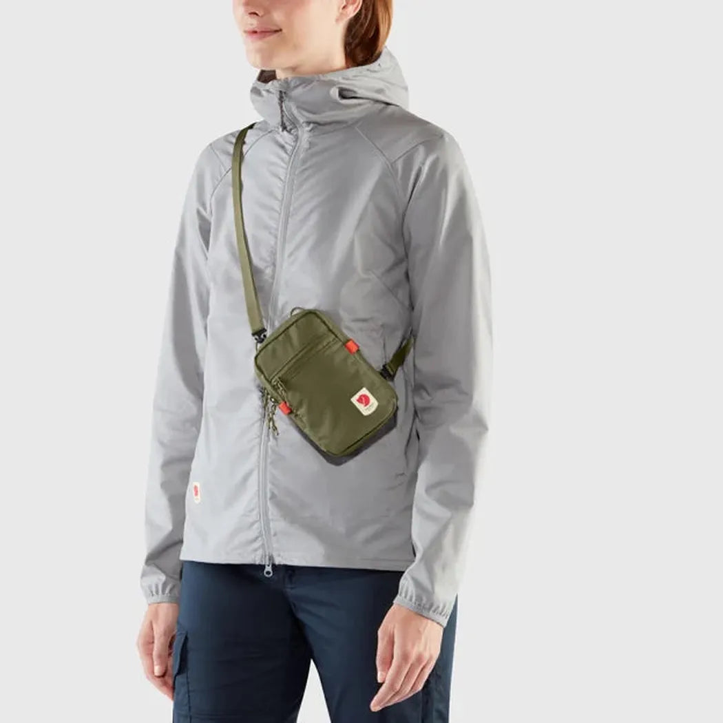 Side view of the Fjallraven High Coast Pocket in Black on a model against a plain background.