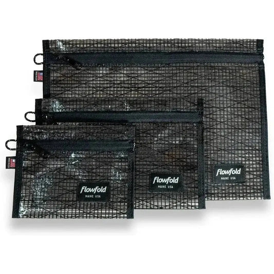 Three black Flowfold recycled sailcloth zipper pouches in varying sizes are displayed against a white background.