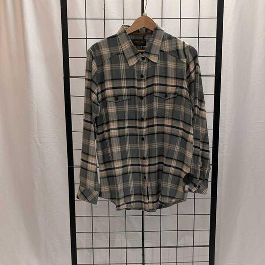 A women's Flyshacker Sample Snuggler Flannel Shirt in Ecru hangs on a wooden hanger against a grid background.