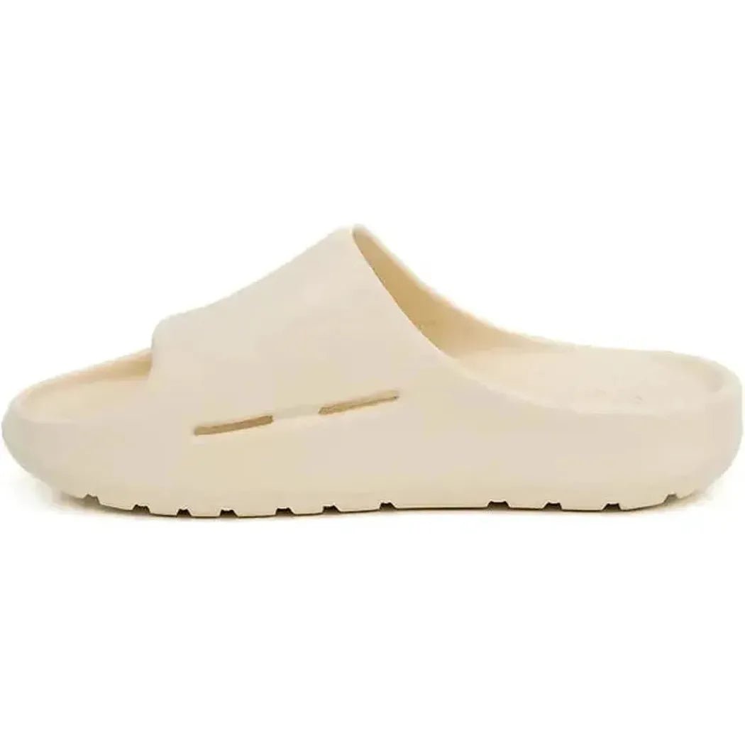 Side view of the Freewaters Women's Cloud9 Slide in Bone showing the open-toe design and textured sole against a white background.