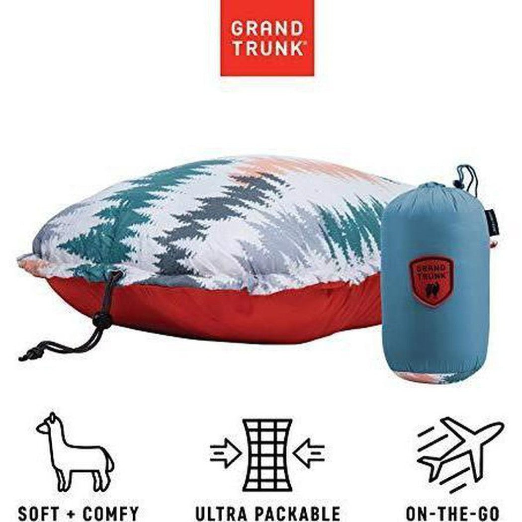 A Grand Trunk adjustable travel pillow in Peacock Green is shown in a side view with its ultra packable blue compression sack, against a white background.