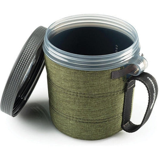 A side view of the GSI Outdoors Infinity Fairshare Mug in Green with its lid off and a black handle visible against a white background.