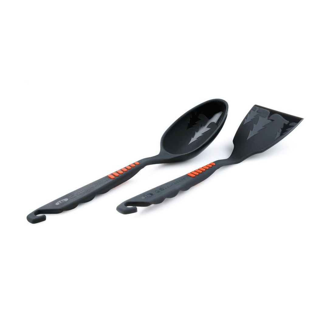 A side view of the GSI Outdoors Pack Spoon/Spatula Set with charcoal handles and orange accents against a white background.