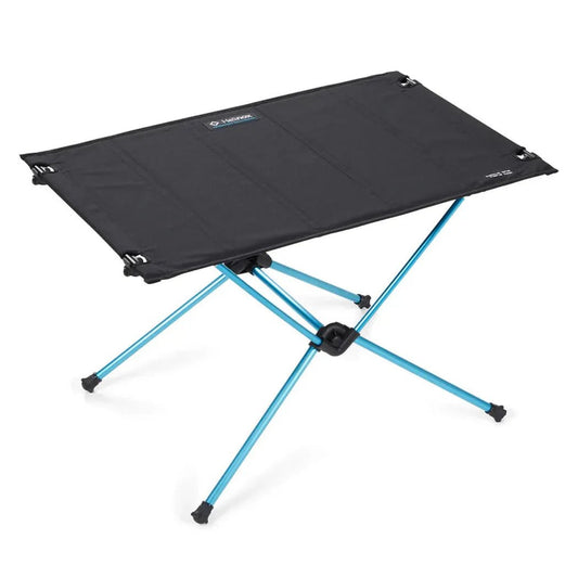 A top-down view of the Helinox Table One Hard Top in Black R1 with blue legs and a black tabletop.