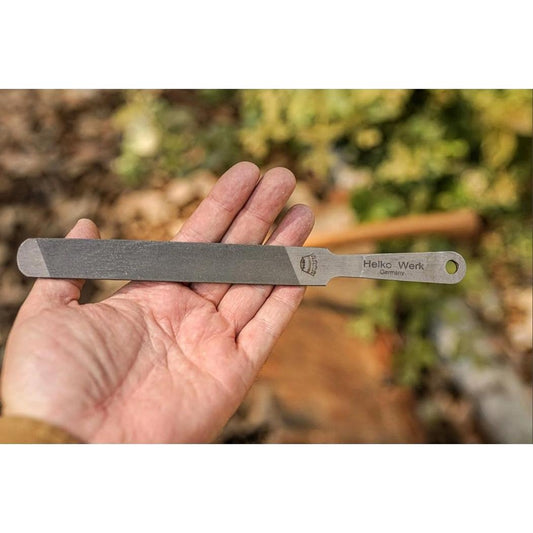 A hand holds the Helko Werk Compact Sharpening File with a natural outdoor background.