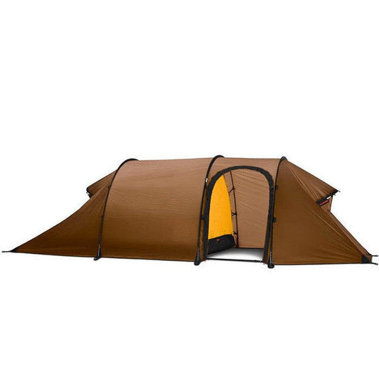 A side view of the Hilleberg Nammatj 2 tent in Green showing the entrance and a white background.