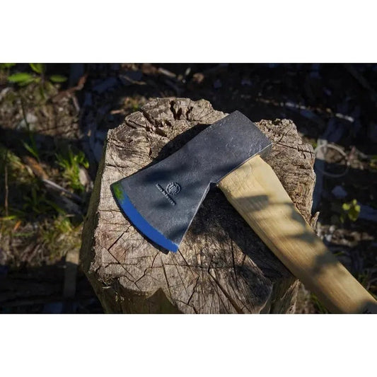 A Hults Bruk Jursla Felling Axe rests on a tree stump with a natural outdoor background.