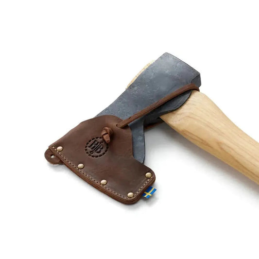 A close-up of the Hults Bruk Stålberg Replacement Sheath with a charcoal/ graphite axe head and light wooden handle against a white background.