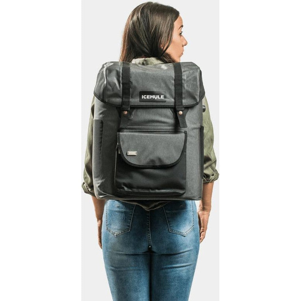 Back view of the IceMule Coolers Urbano 30L in Snow Grey on a model wearing blue jeans against a plain background.