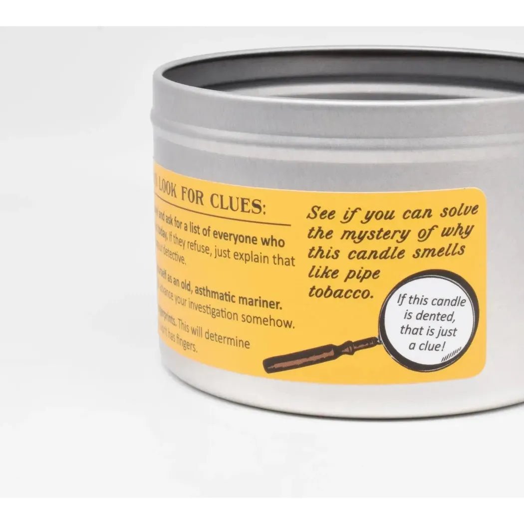 A close up of the JD and Kate Industries Sherlock Holmes Scented Candle tin showing the yellow label and magnifying glass graphic against a white background.