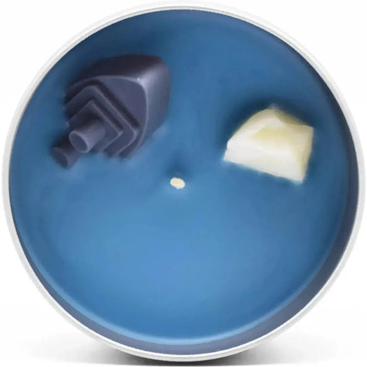 A blue JD and Kate Industries Titanic Scented Candle with a dark charcoal/gray shape and a light yellowish piece on top.