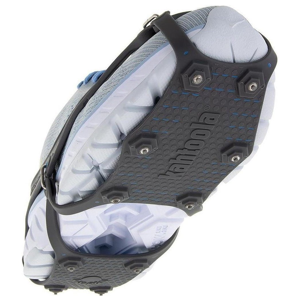 A top-down view of the Kahtoola NANOspikes Footwear Traction in Black, showing the spiked traction plate and attached to a light-colored shoe.