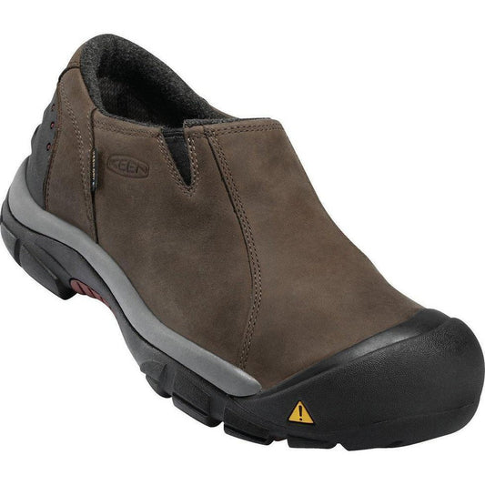Side view of the Keen Men's Brixen Waterproof Low in Slate Black/Madder Brown showing the black rubber toe cap and yellow warning triangle against a white background.