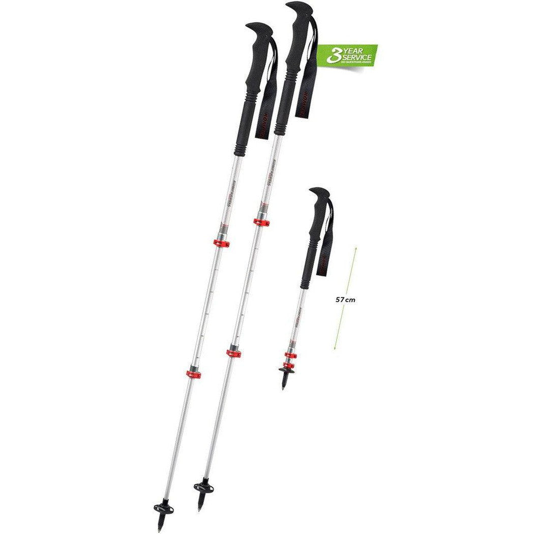 Two Komperdell Explorer Compact Powerlock trekking poles with black handles and red accents, one extended and one folded to 57cm, against a white background with a 3 year service tag.