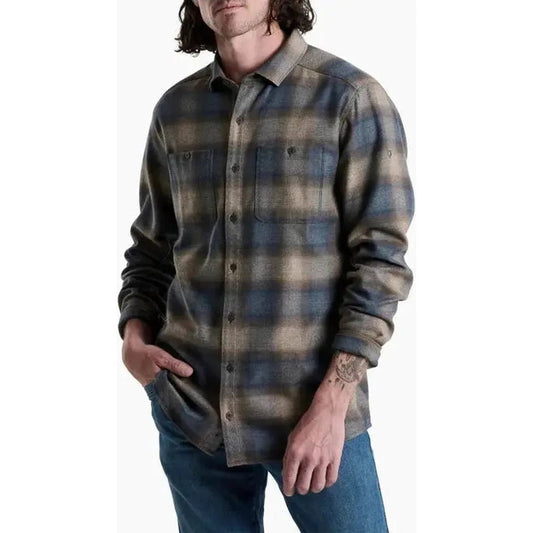 A front view of the Kuhl Men's Law Flannel Long Sleeve in Fog Harbor, showing the model wearing it with blue jeans against a white background.