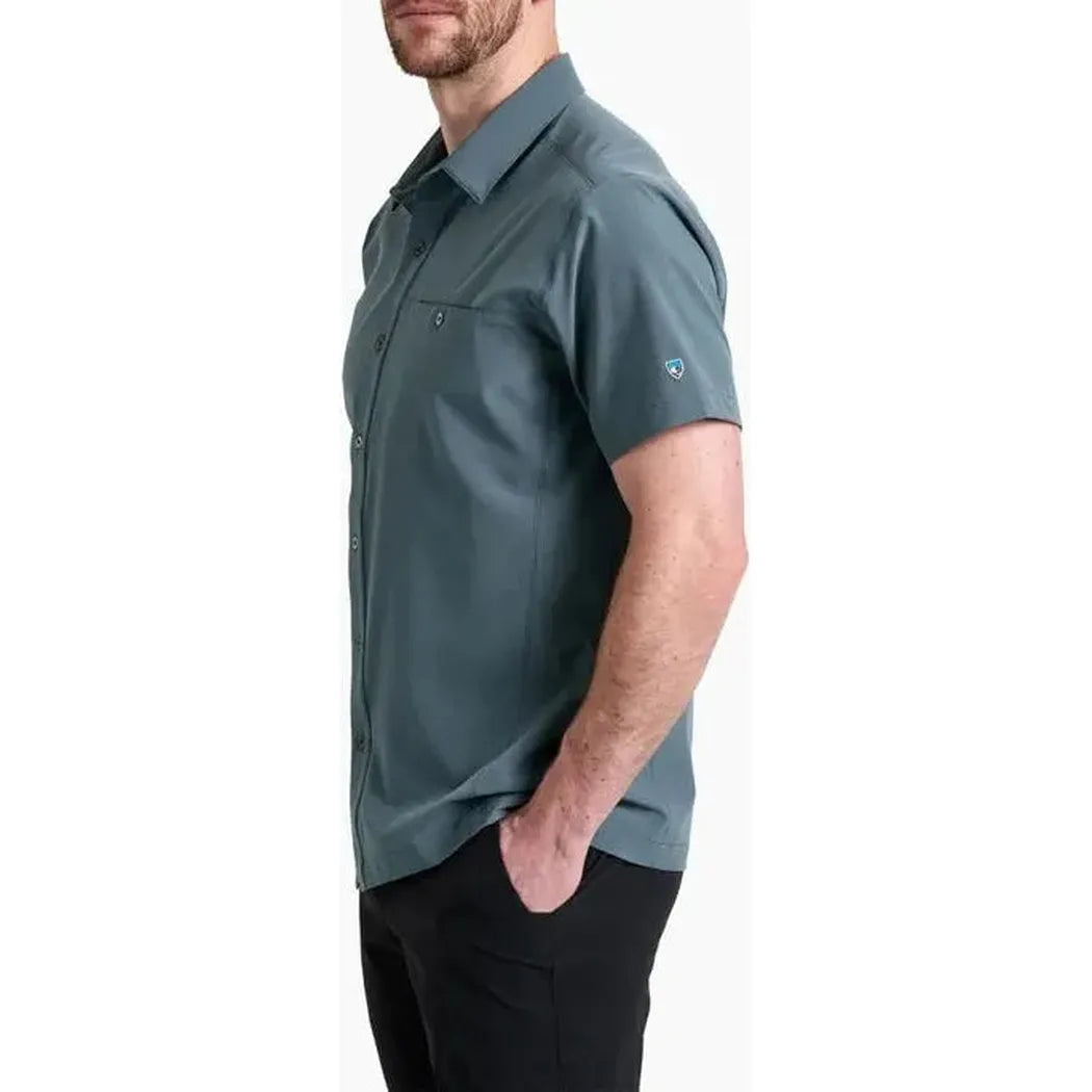 Side view of the Kuhl Men's Renegade Shirt in Charcoal Blue with a model wearing it against a white background.
