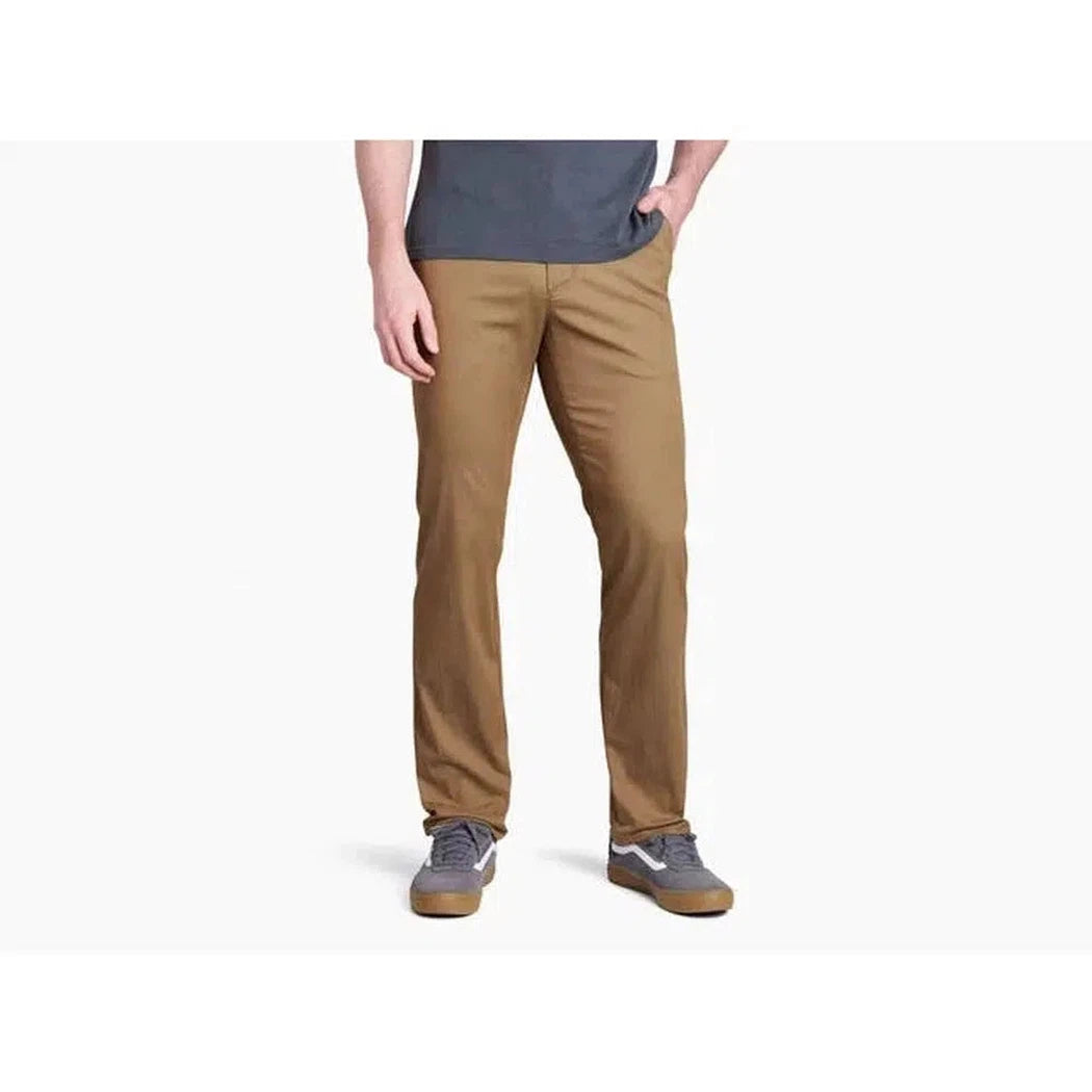A front view of the Kuhl Men's Resistor Lite Chino in Carbon on a model wearing gray sneakers against a white background.