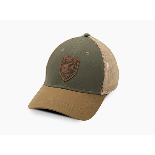 A front view of the Kuhl Rustik Born Trucker hat in Desert Oasis with a brown front panel and mesh back, displayed against a white background.