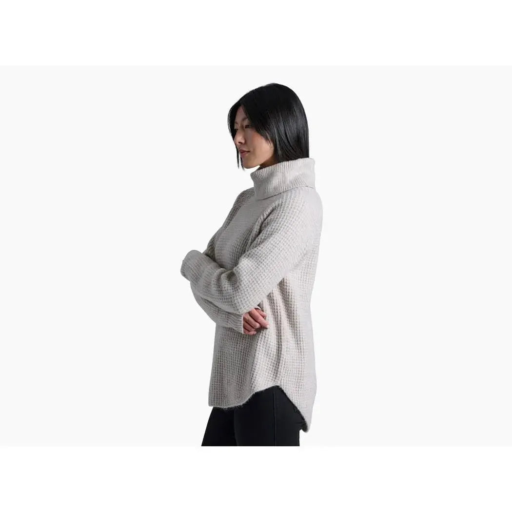 Side view of the Kuhl Women's Sienna Sweater in Cherrywood showing the turtleneck and model wearing it against a white background.