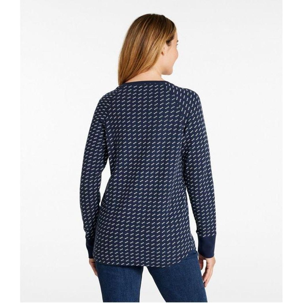 Back view of the L.L.Bean Women's Unshrinkable Mini-Waffle Long-Sleeve Crewneck Stripe Tee in Classic Navy Birdseye on a model wearing blue jeans against a white background.