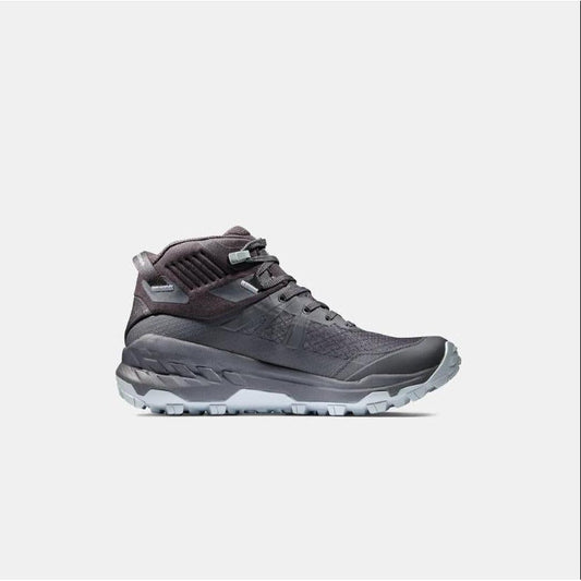 Side view of the Mammut Sports Group Sertig II Mid GTX Women in Black showing the lugged outsole against a white background.
