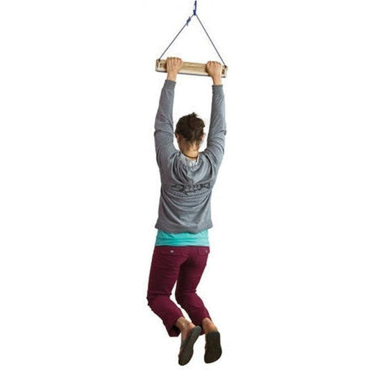 A woman hangs from the Metolius Light Rail training gear against a white background.