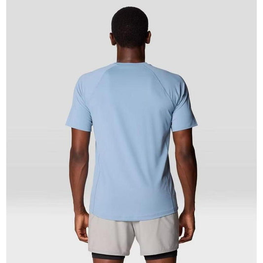 Back view of the Mountain Hardwear Men's Crater Lake Short Sleeve in Element color on a model wearing light gray shorts against a plain background.